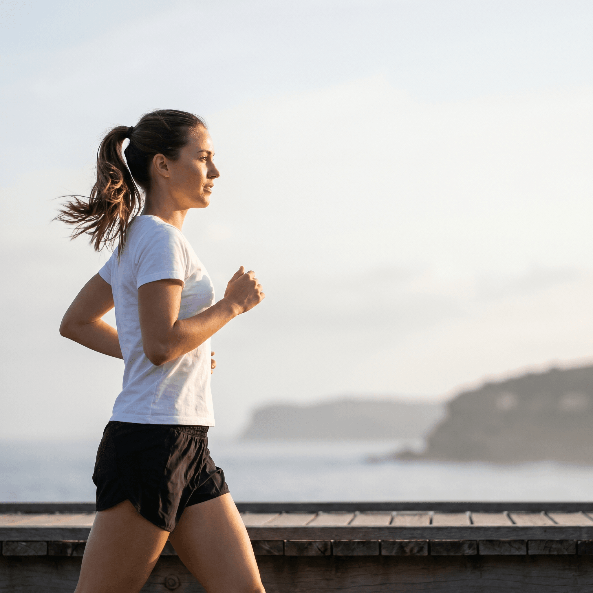 Australian woman running on a coastal boardwalk